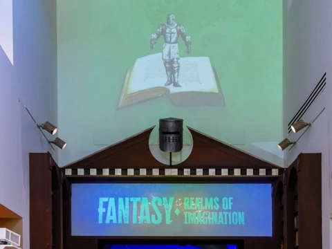 Projected knight and book above the Fantasy: Realms of Imagination exhibition entrance