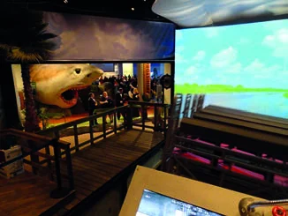 Airboat seating and themed dock inside the theater