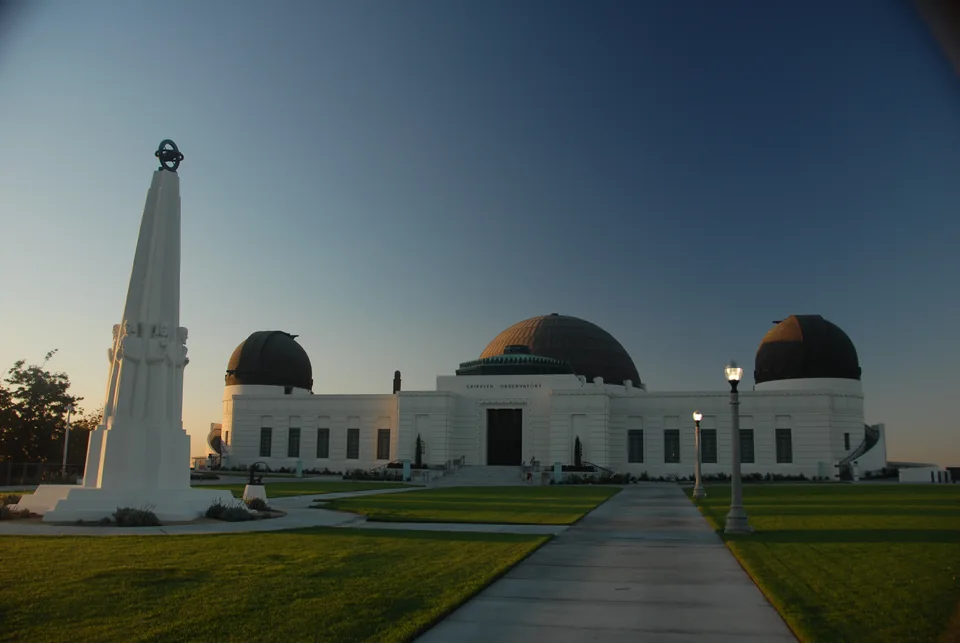 Griffith Observatory and its astronomical monument at dusk